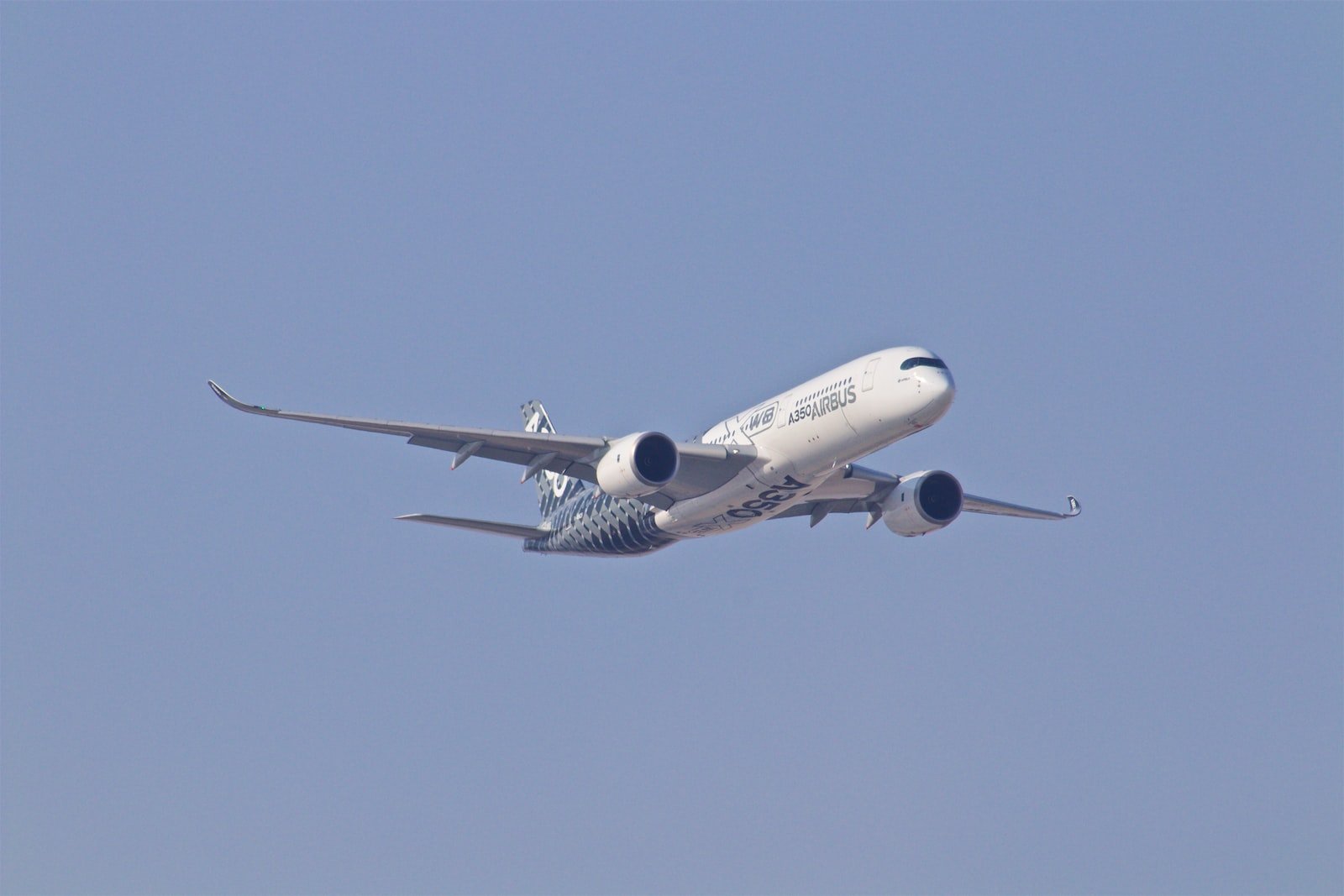 white airplane taking off during daytime