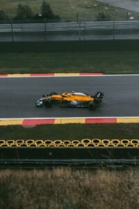 yellow and black sports car on track field