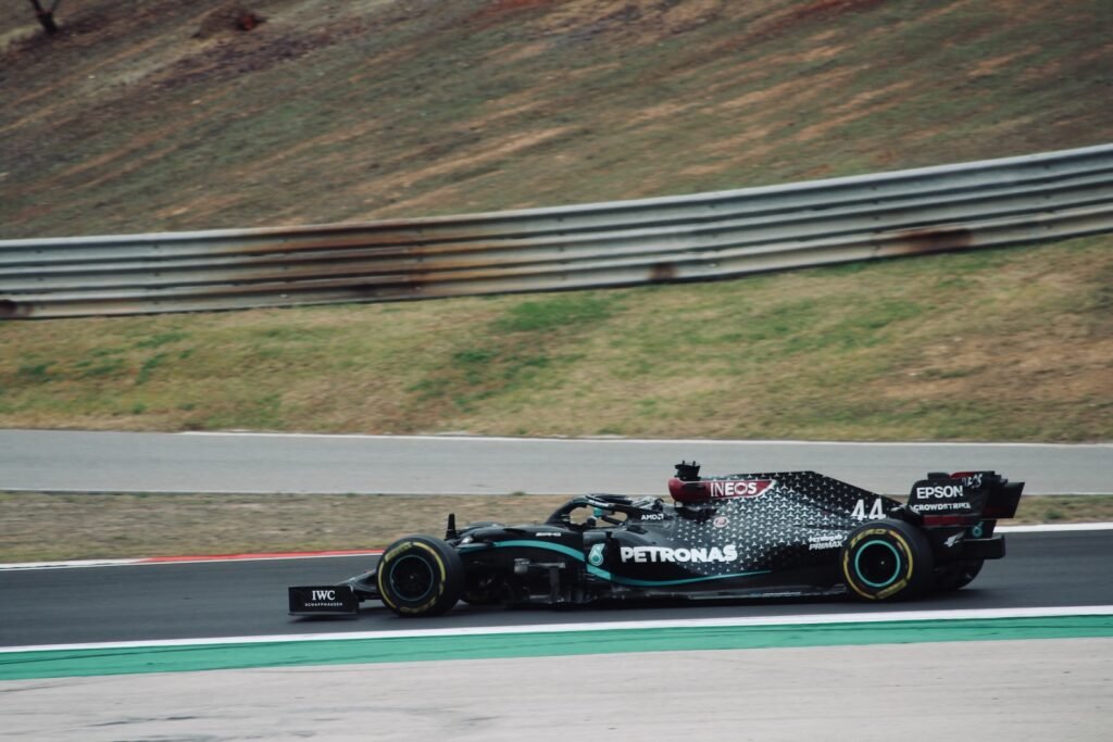 black and white f 1 car on road during daytime