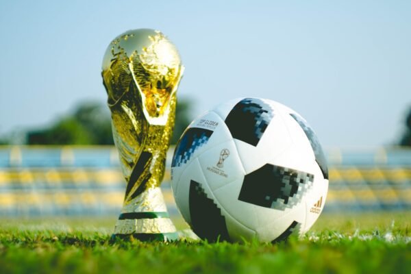 gold-colored trophy and soccerball